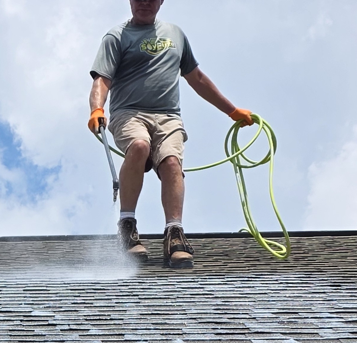 SoyFuze applicator spraying a shingle roof with the professional spray wand