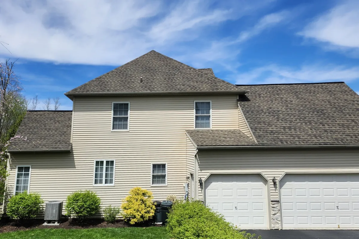 Same tan colonial house roof after SoyFuze soy oil roof rejuvenation treatment, with darker shingles